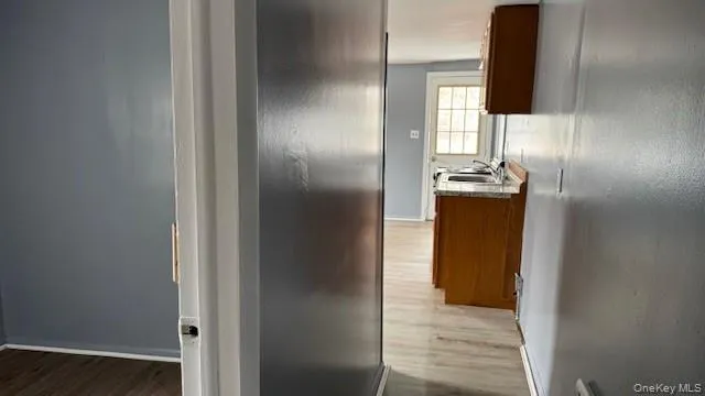 a view of hallway with wooden floor