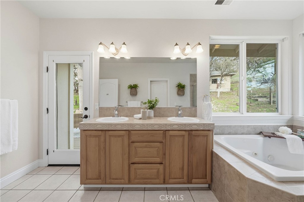 19429 Moon Ridge Road Hidden Valley Lake, CA 95467 - Photo 42 of 75 a bathroom with a granite countertop sink and a mirror