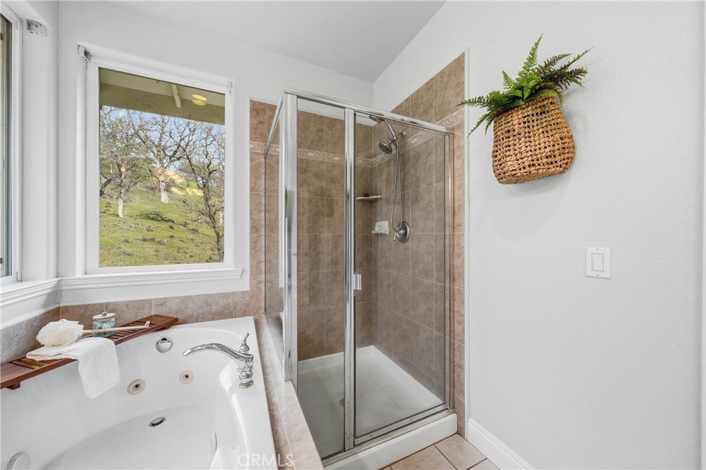 19429 Moon Ridge Road Hidden Valley Lake, CA 95467 - Photo 43 of 75 a bathroom with a tub and a shower