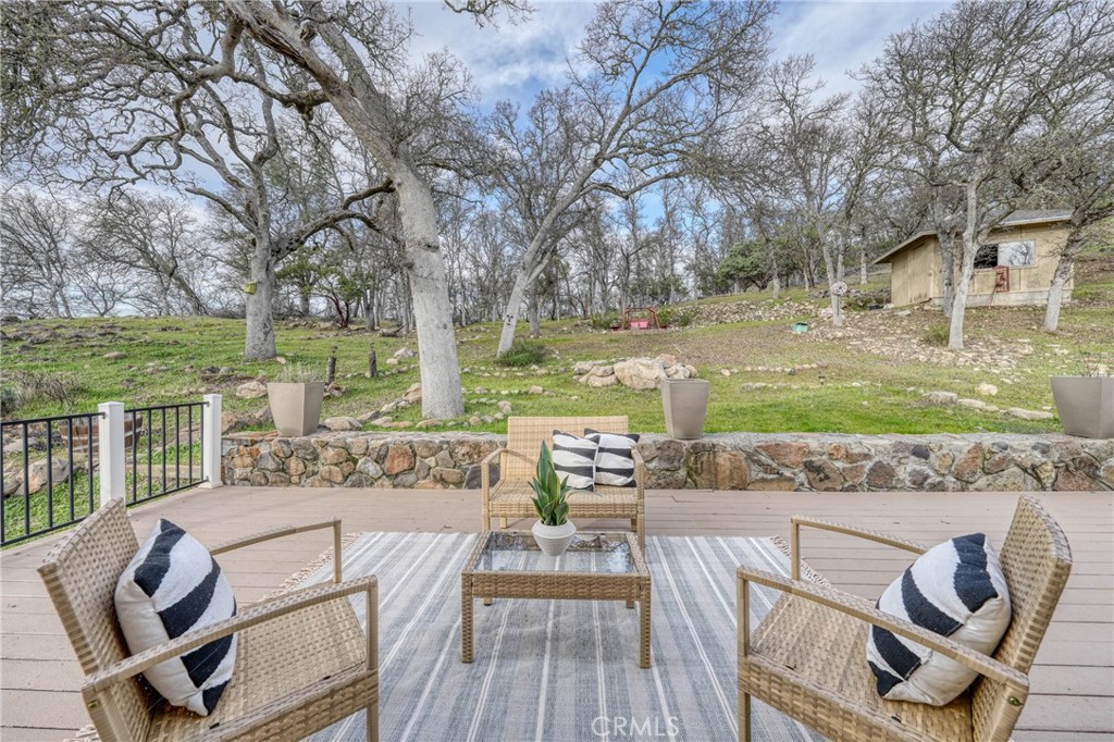 19429 Moon Ridge Road Hidden Valley Lake, CA 95467 - Photo 50 of 75 a view of a patio with lawn chairs floor to ceiling window and yard