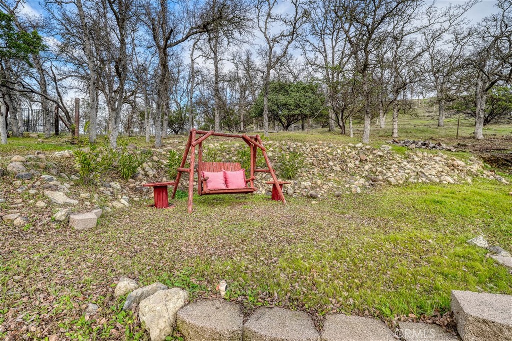 19429 Moon Ridge Road Hidden Valley Lake, CA 95467 - Photo 54 of 75 a backyard of a house with trees and outdoor seating