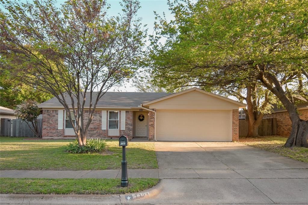Ranch-style home with an attached garage, brick siding, and concrete driveway