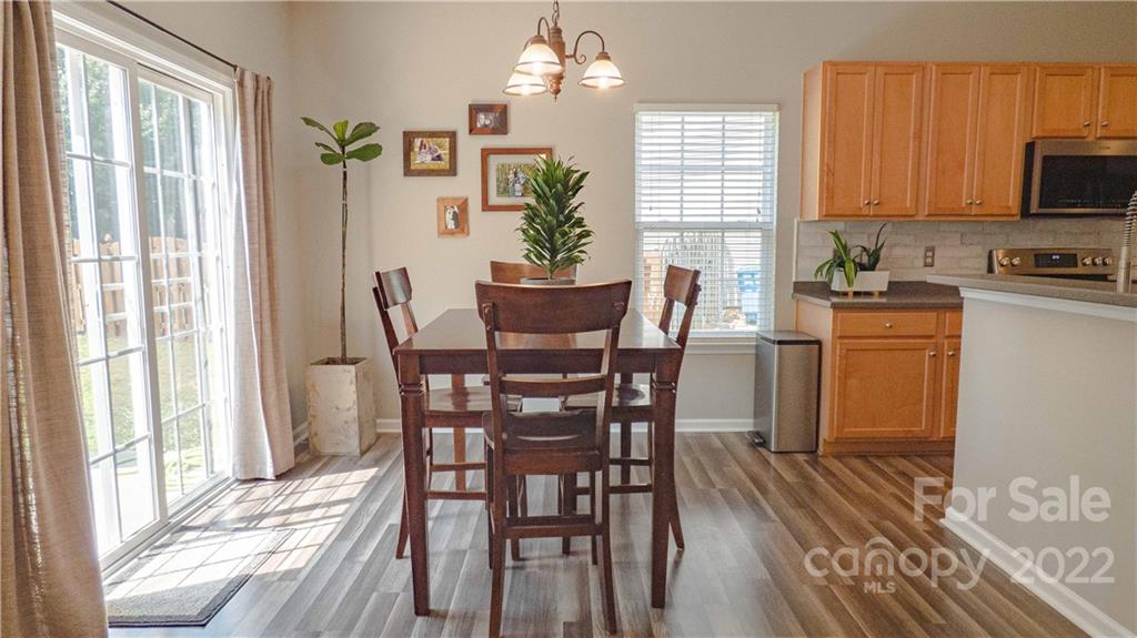 3303 Burnage Hall Road Harrisburg, NC 28075 - Photo 14 of 37 a view of a dining room with furniture window and wooden floor