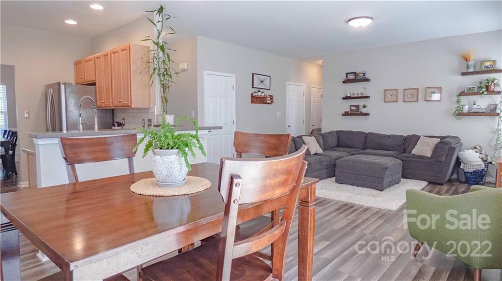 3303 Burnage Hall Road Harrisburg, NC 28075 - Photo 15 of 37 a view of a dining room with furniture and wooden floor