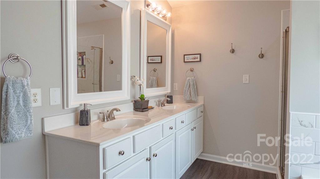 3303 Burnage Hall Road Harrisburg, NC 28075 - Photo 20 of 37 a bathroom with a sink and a mirror