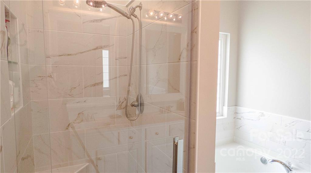 3303 Burnage Hall Road Harrisburg, NC 28075 - Photo 22 of 37 a bathroom with a shower