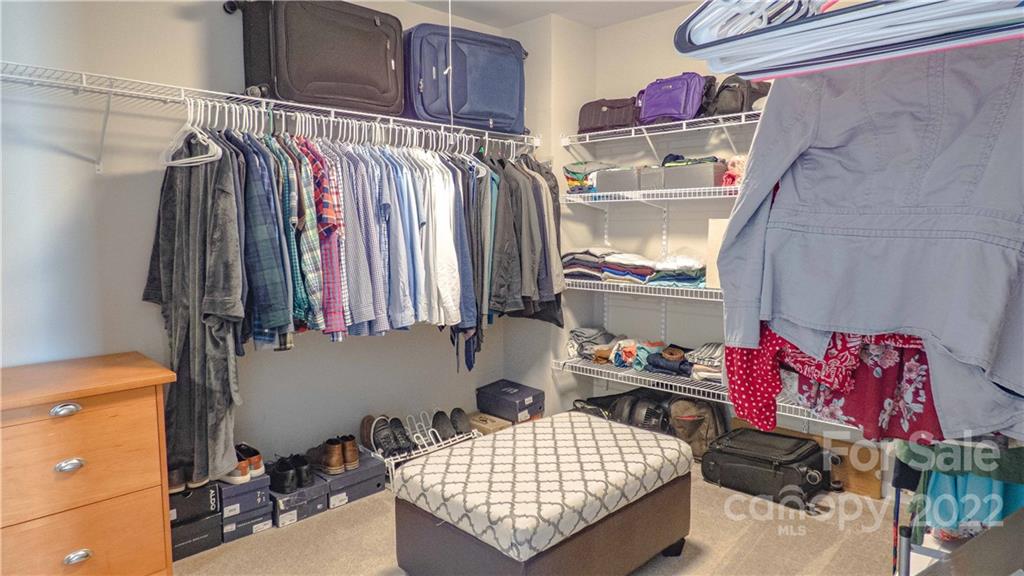 3303 Burnage Hall Road Harrisburg, NC 28075 - Photo 23 of 37 a view of walk in closet with clothes and shoes