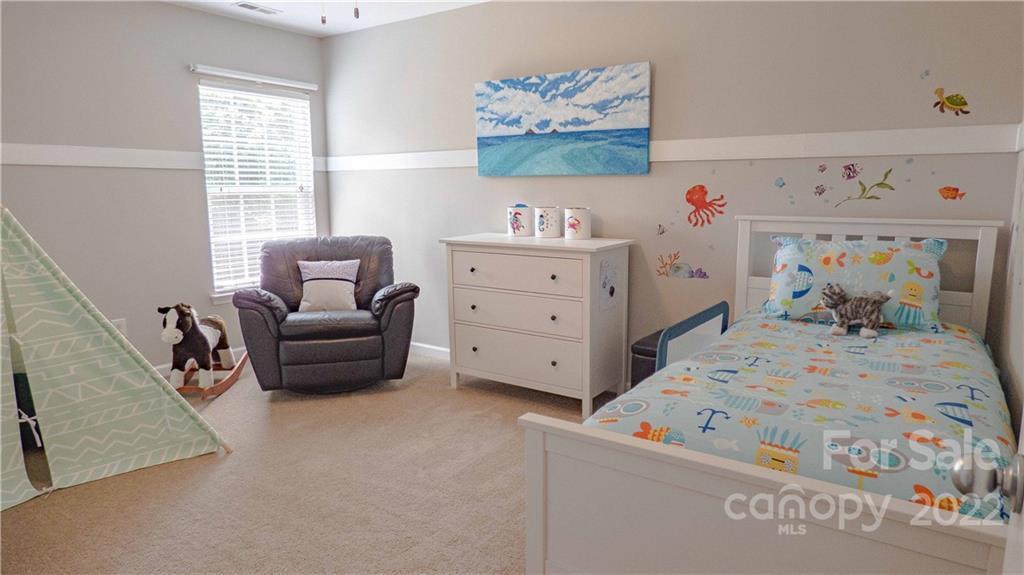 3303 Burnage Hall Road Harrisburg, NC 28075 - Photo 24 of 37 a bedroom with furniture and a window
