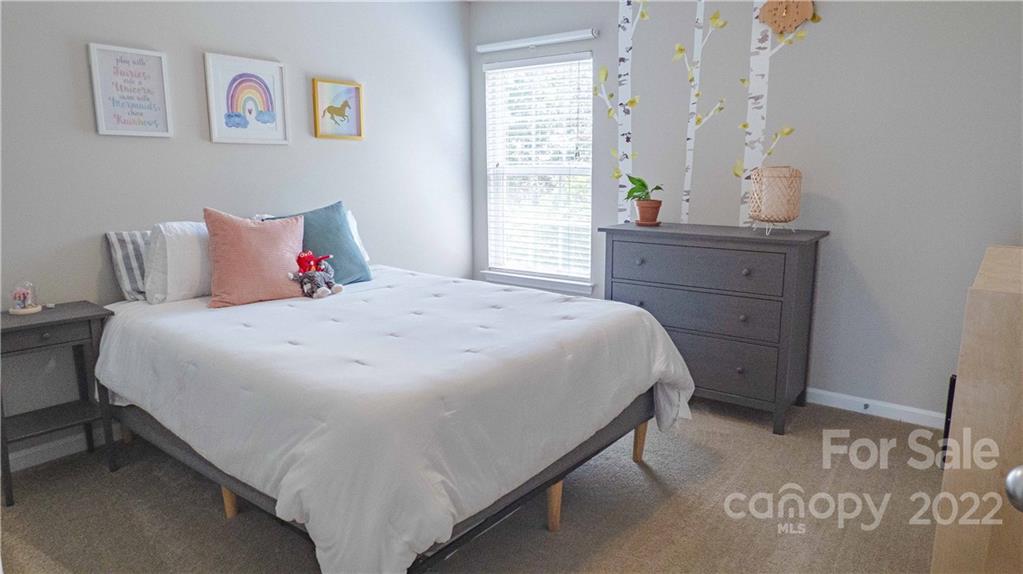 3303 Burnage Hall Road Harrisburg, NC 28075 - Photo 27 of 37 a bedroom with a bed and window