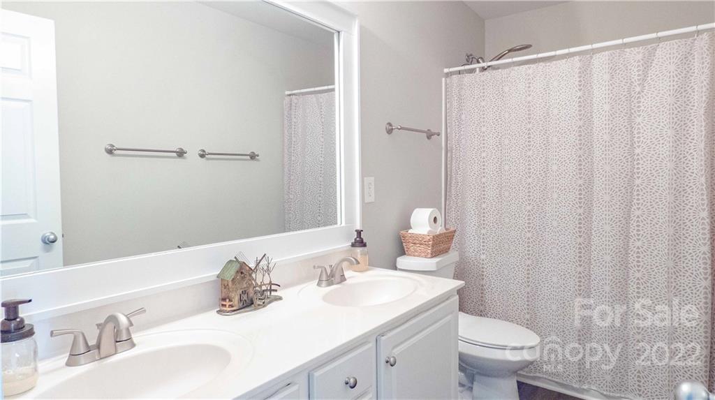 3303 Burnage Hall Road Harrisburg, NC 28075 - Photo 28 of 37 a bathroom with a sink toilet and shower