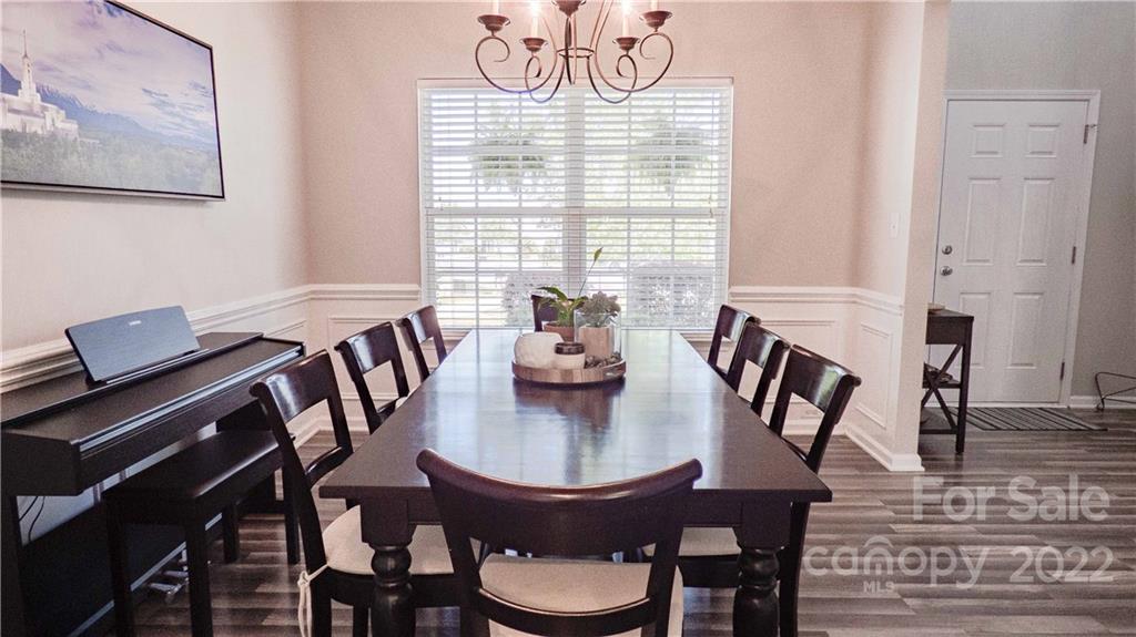 3303 Burnage Hall Road Harrisburg, NC 28075 - Photo 3 of 37 a view of a dining room with furniture window and wooden floor
