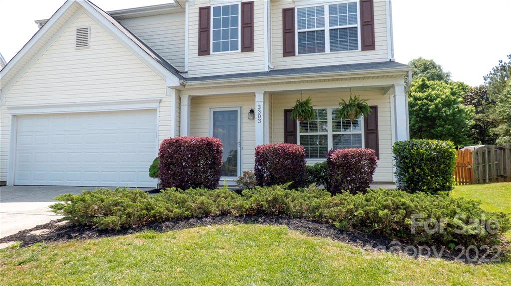 3303 Burnage Hall Road Harrisburg, NC 28075 - Photo 36 of 37 a view of a house with large windows and flower plants