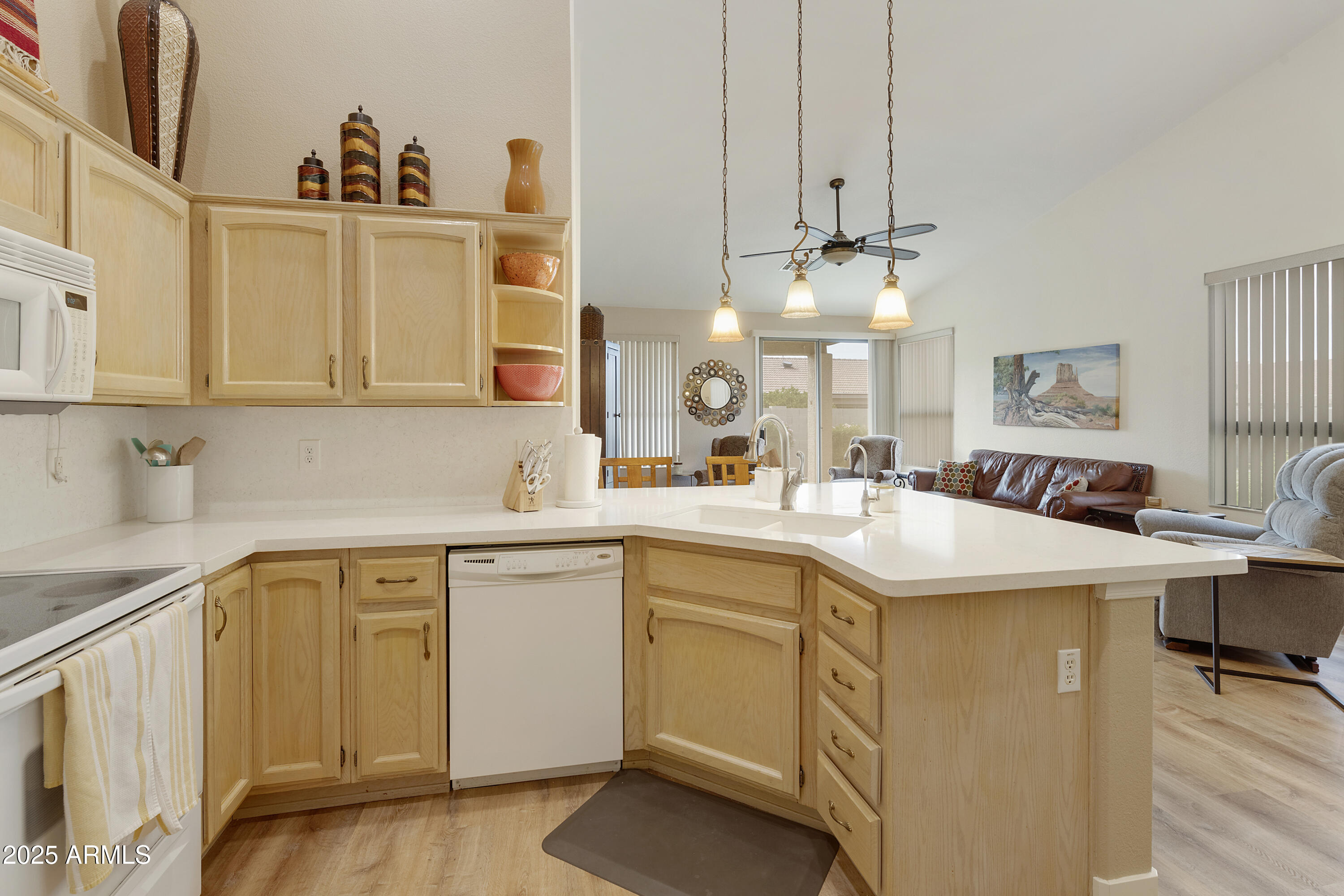 23745 South Vacation Way Sun Lakes, AZ 85248 - Photo 10 of 52 a kitchen with a sink dishwasher and white cabinets with wooden floor