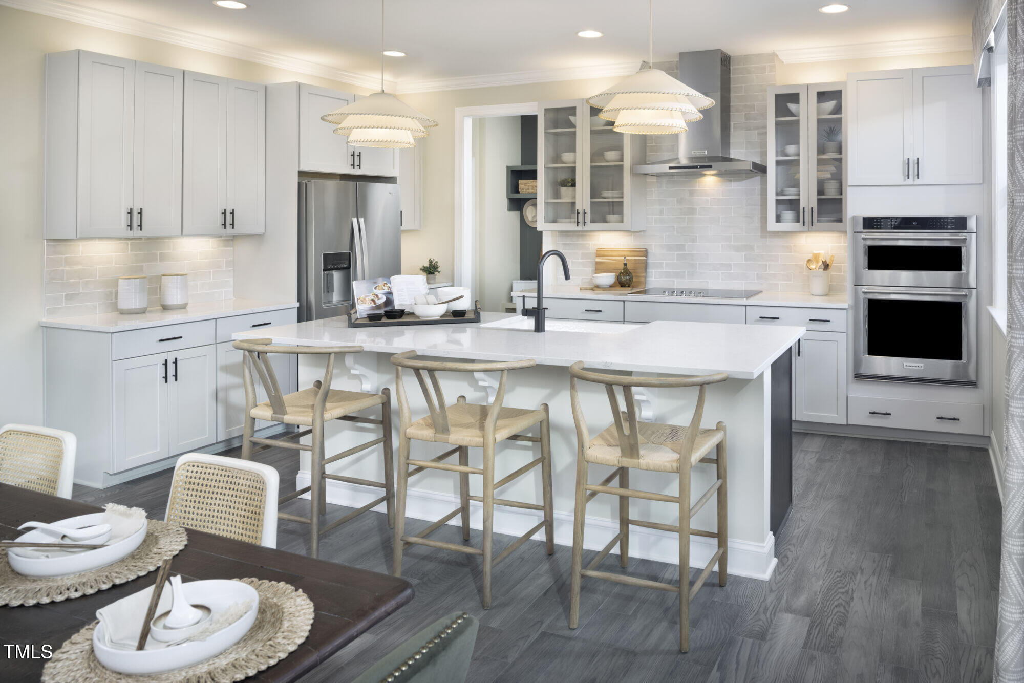 a kitchen with stainless steel appliances granite countertop a stove a sink a dining table and chairs