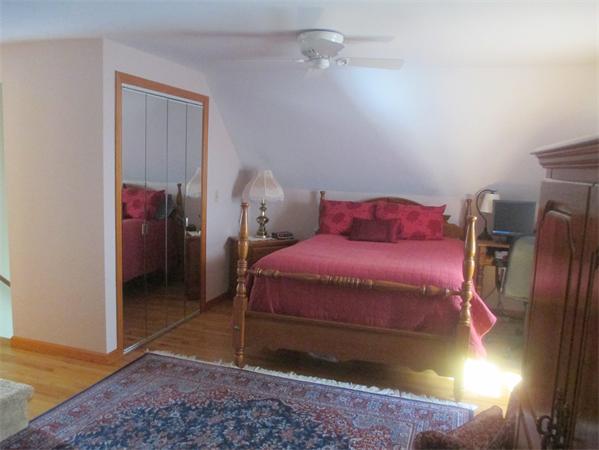 184 Powell Avenue Springfield, MA 01118 - Photo 8 of 14 a bedroom with a bed and a chandelier