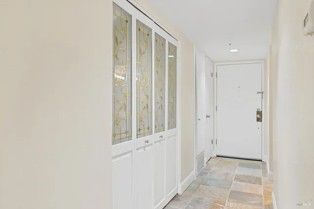 a view of a hallway with wooden floor and entryway