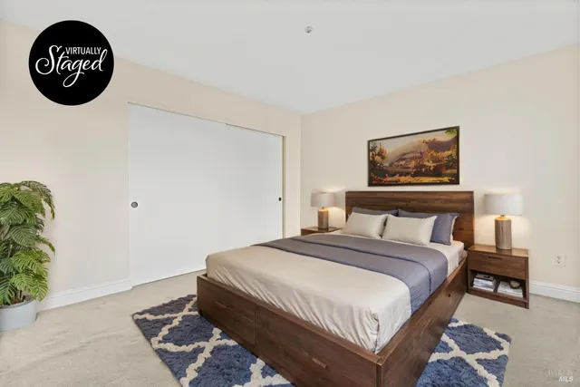 a bedroom with a bed and a painting on the wall