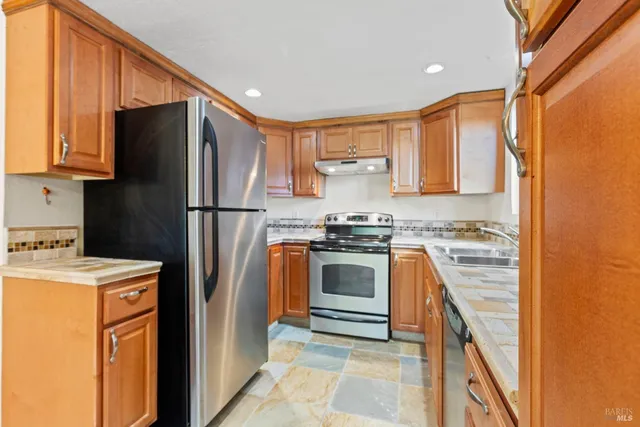 a kitchen with a refrigerator sink and stove