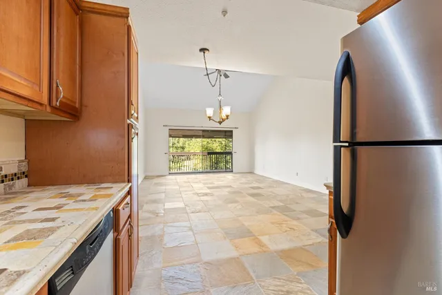 a view of a kitchen cabinets a sink and a refrigerator