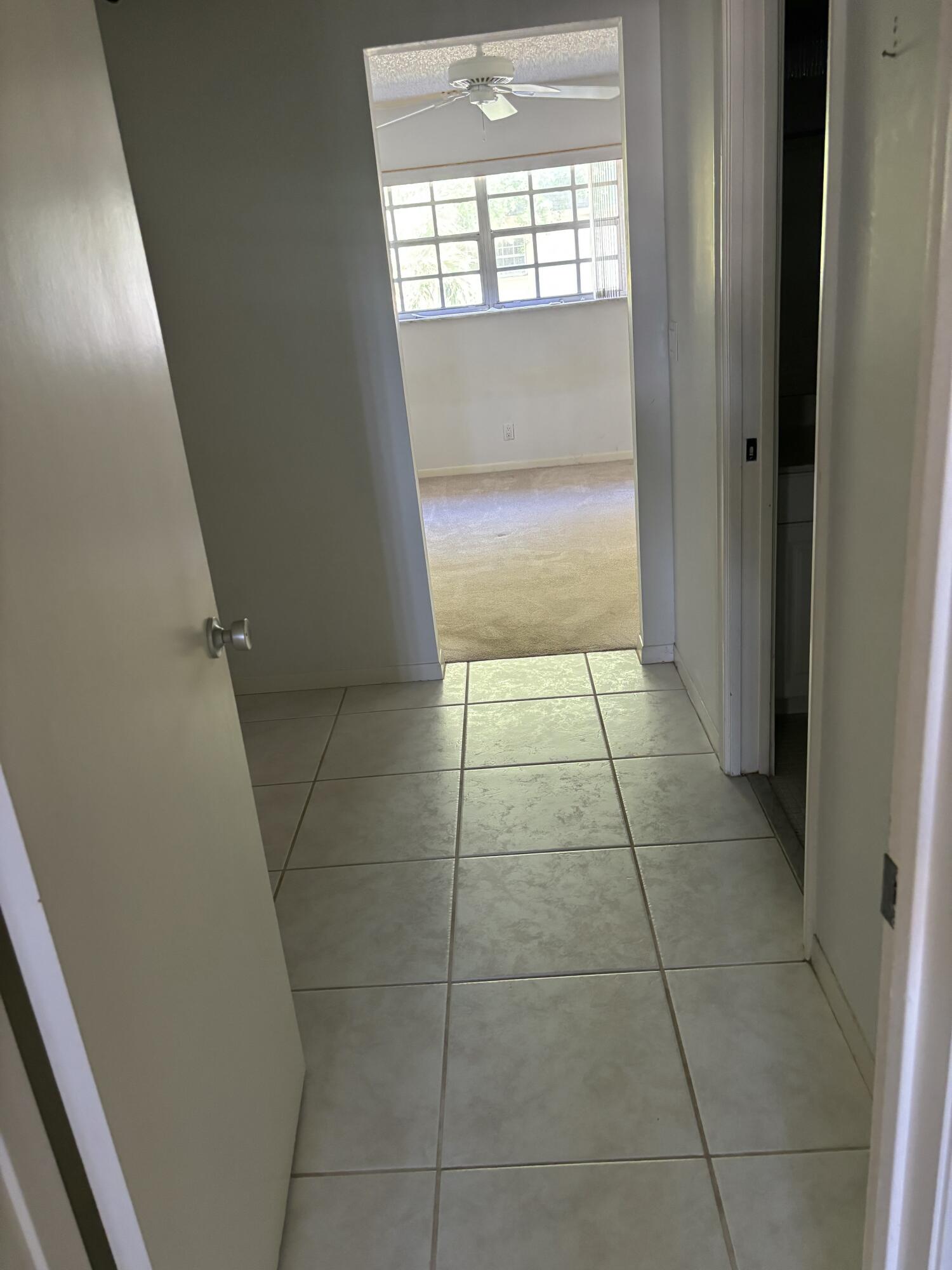 1700 Dover Road, Unit 215A Delray Beach, FL 33445 - Photo 15 of 23 a hallway with window