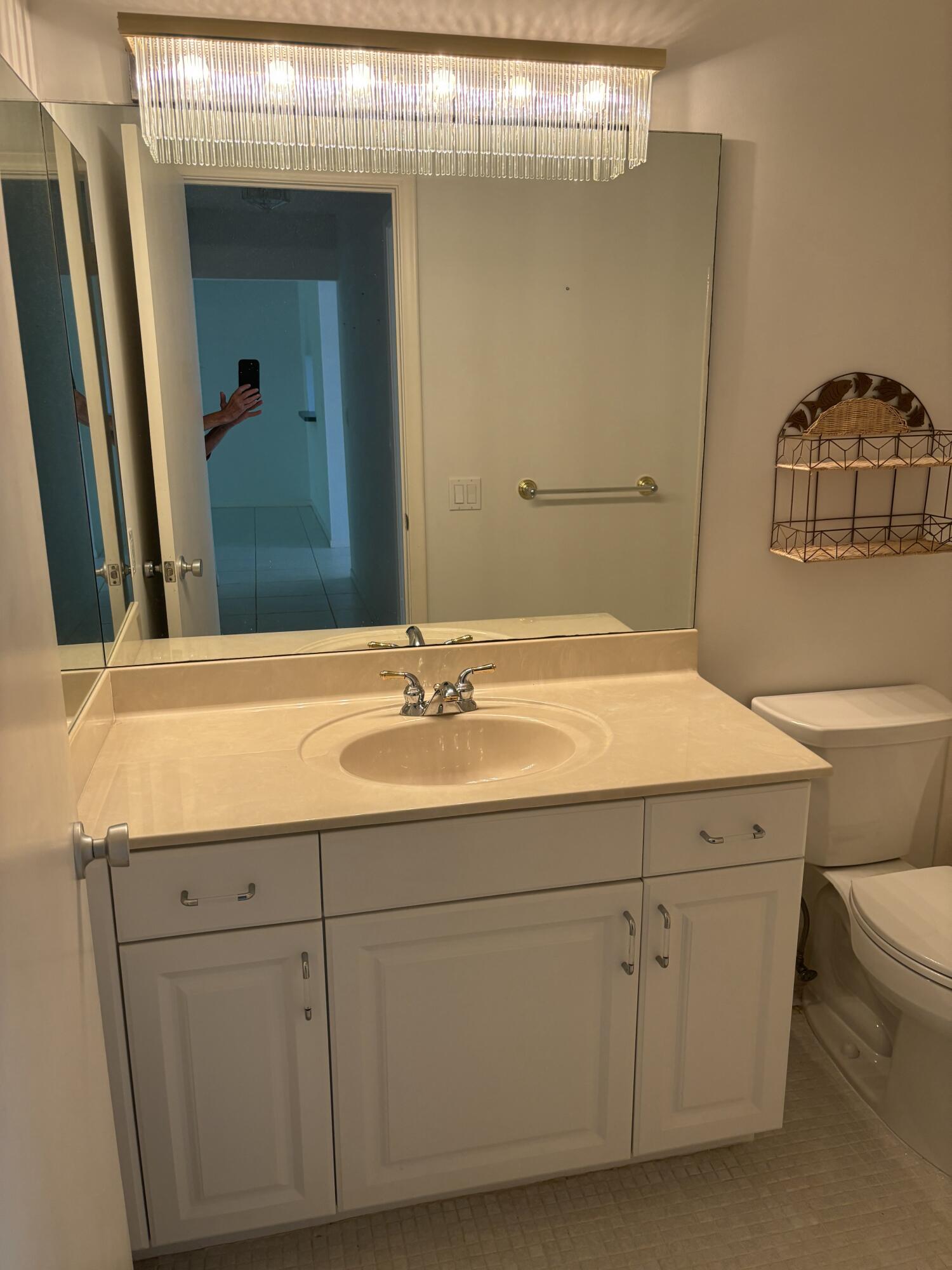 1700 Dover Road, Unit 215A Delray Beach, FL 33445 - Photo 17 of 23 a bathroom with a sink and a mirror
