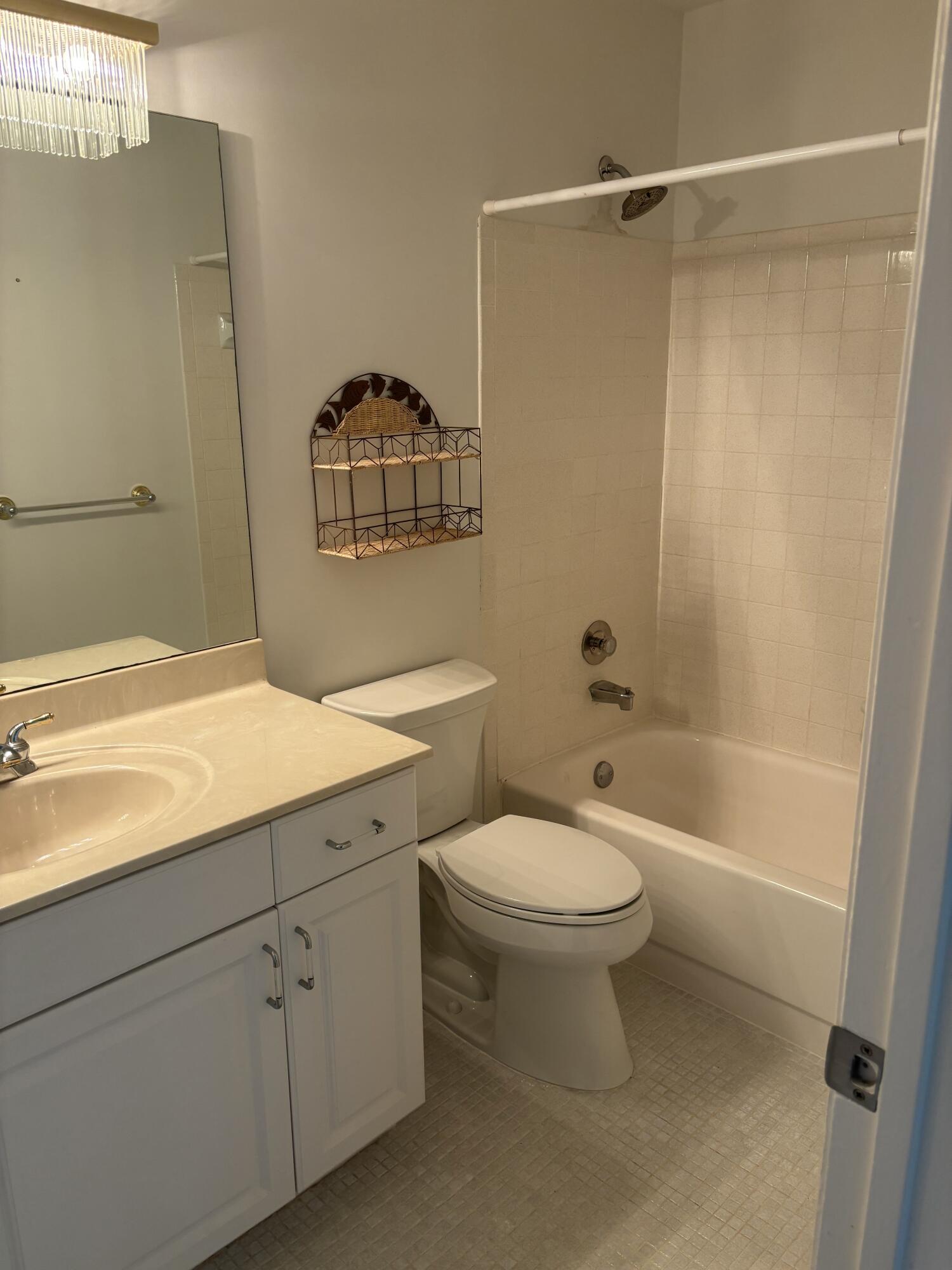 1700 Dover Road, Unit 215A Delray Beach, FL 33445 - Photo 20 of 23 a bathroom with a sink a toilet and shower
