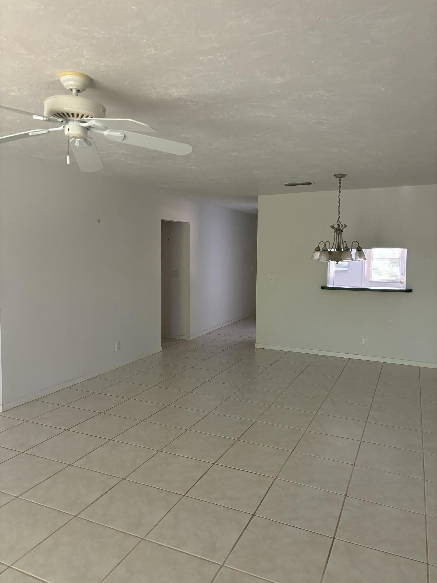 1700 Dover Road, Unit 215A Delray Beach, FL 33445 - Photo 2 of 23 a view of a livingroom and a chandelier fan