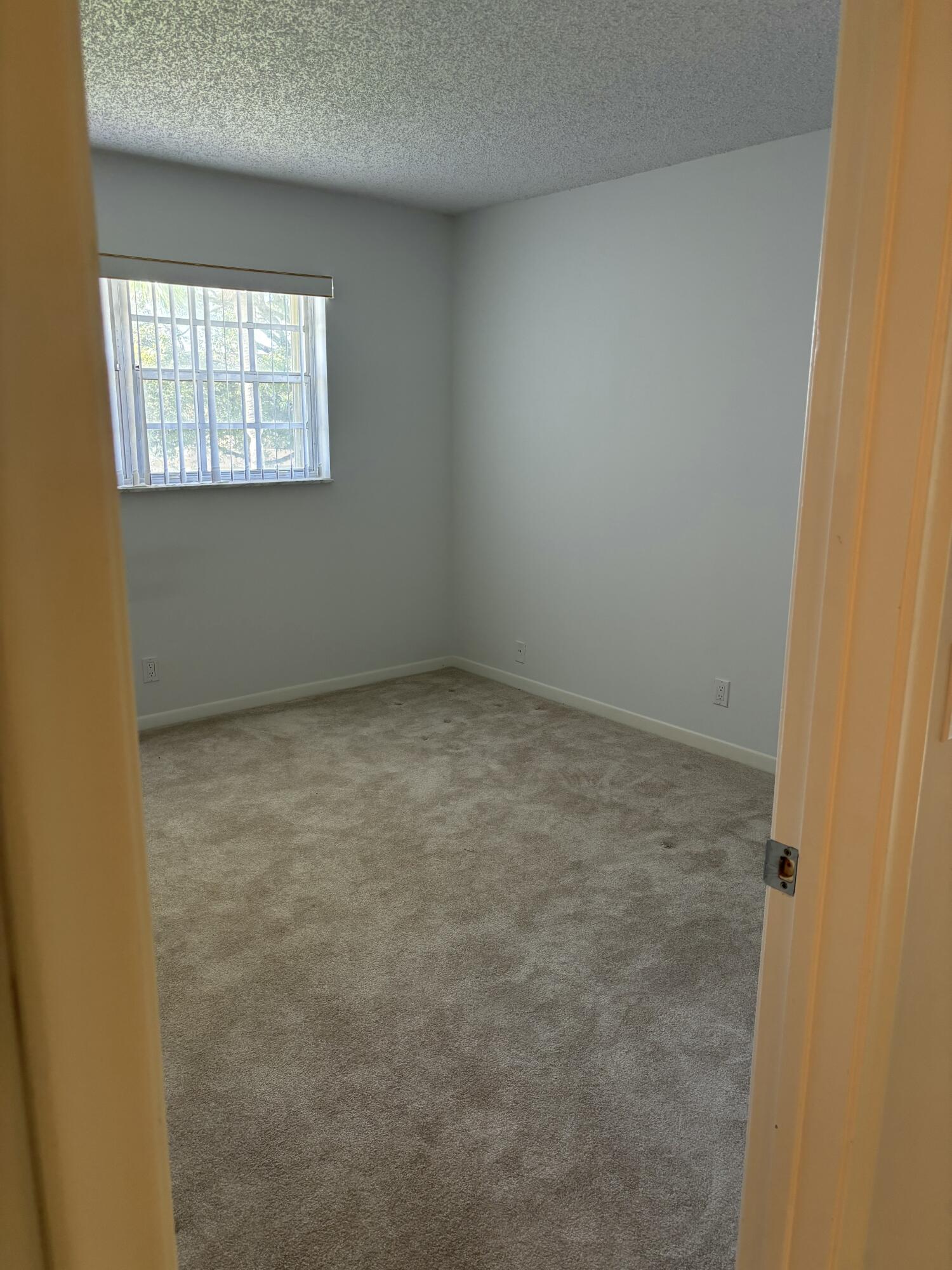 1700 Dover Road, Unit 215A Delray Beach, FL 33445 - Photo 23 of 23 an empty room with windows