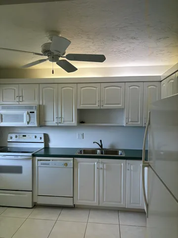 a kitchen with a sink stainless steel appliances and cabinets