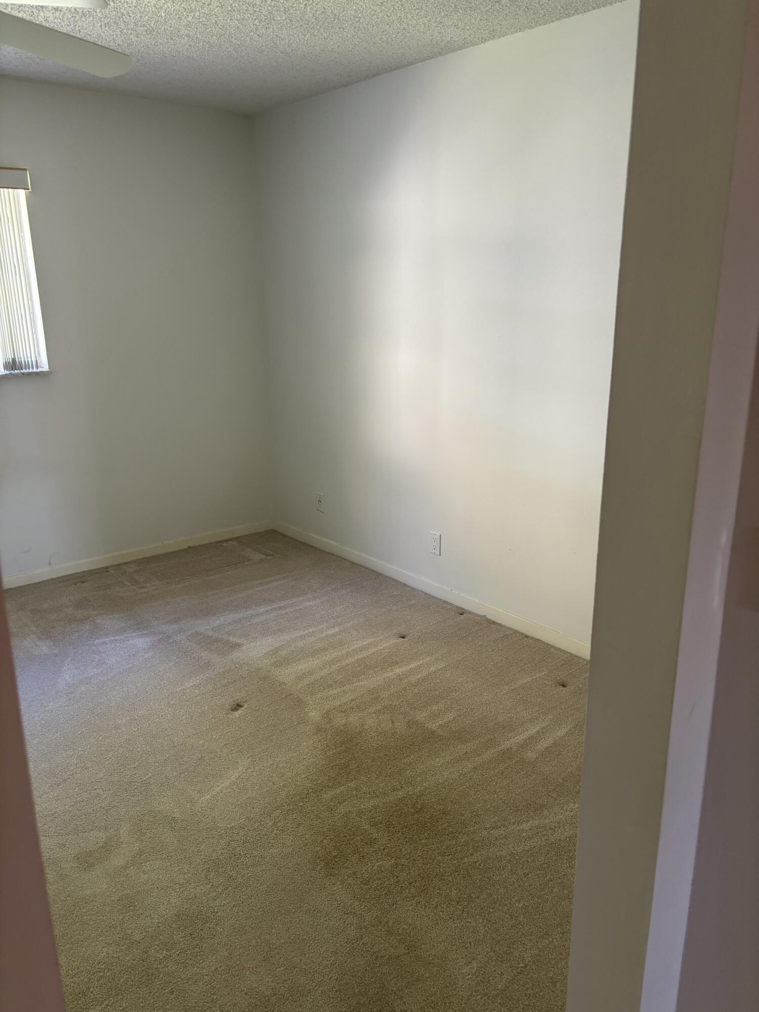 1700 Dover Road, Unit 215A Delray Beach, FL 33445 - Photo 10 of 23 an empty room with a window