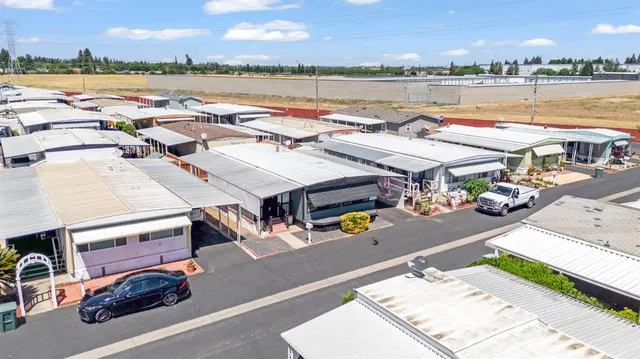 a kitchen with granite countertop a stove and white cabinets