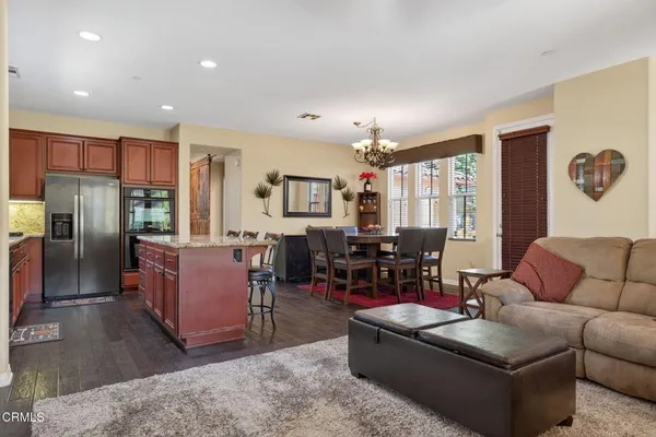 a living room with furniture and kitchen view