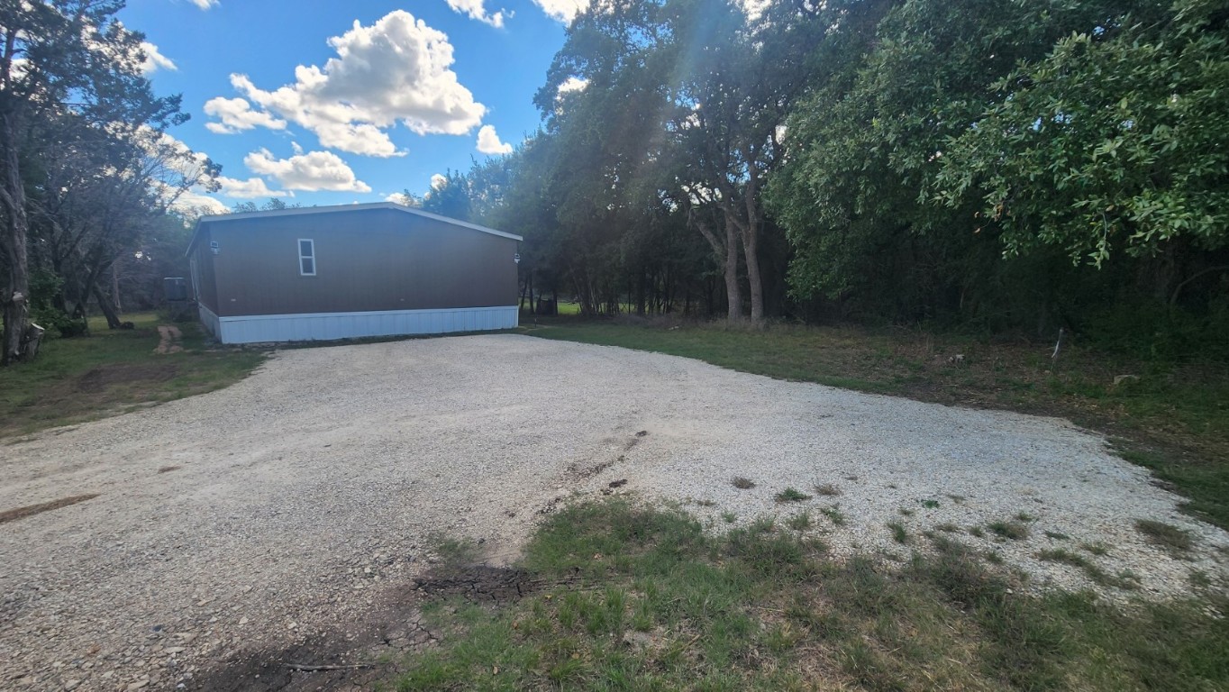25615 Ronald Reagan Boulevard Georgetown, TX 78633 - Photo 17 of 25 a view of a yard with a large tree