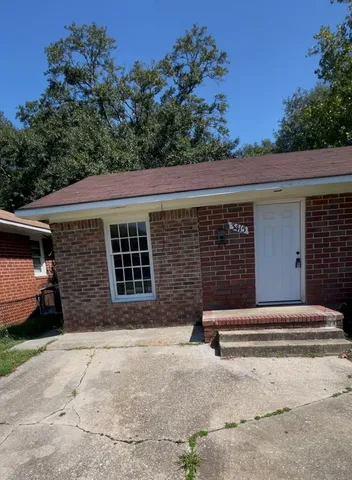 a front view of a house with a yard and a garage