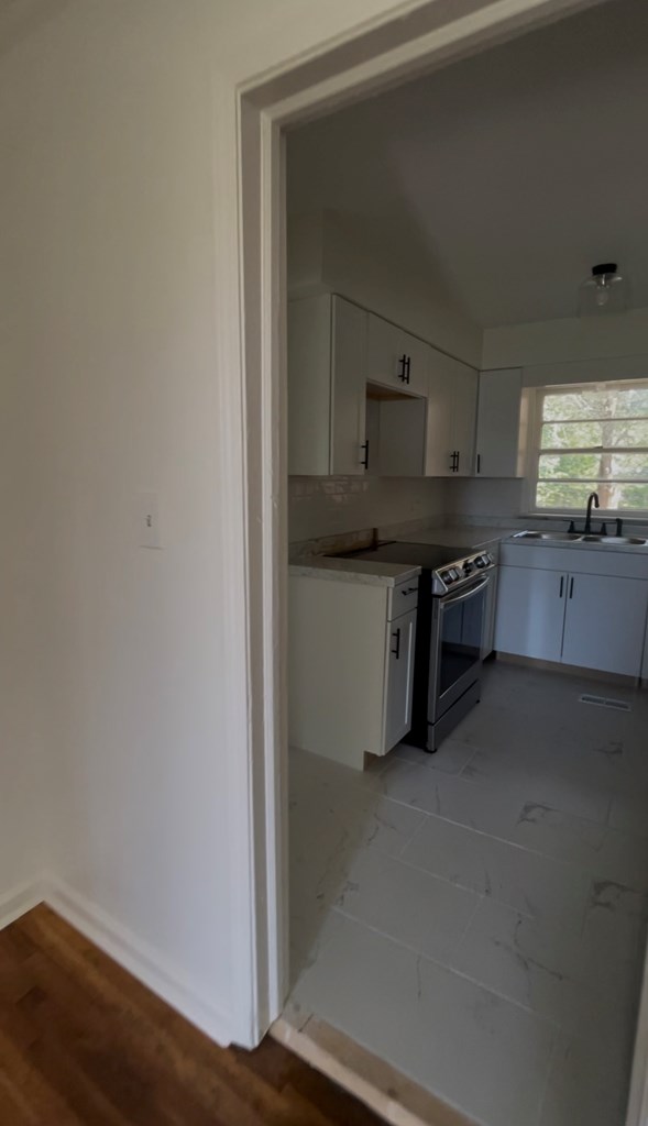 3415 Terminal Street Columbus, GA 31906 - Photo 5 of 6 a kitchen with stainless steel appliances granite countertop a stove and a refrigerator