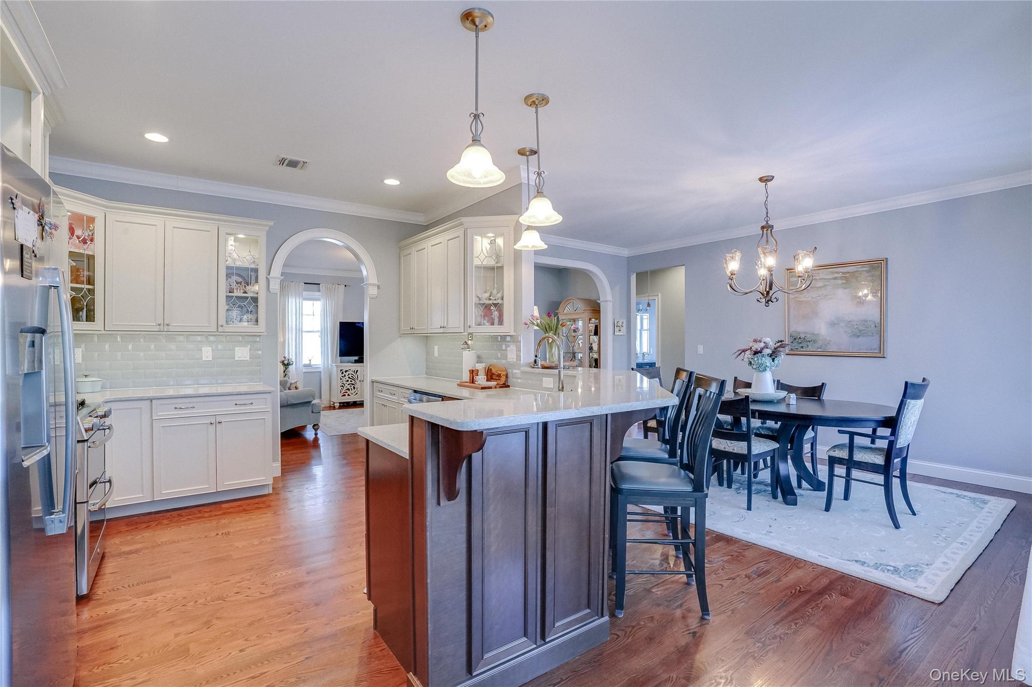 23 Swan Holw Road New Windsor, NY 12553 - Photo 11 of 34 The open-concept kitchen is thoughtfully designed to capture sweeping views of the reservoir, creating a light-filled space where cooking, dining, and entertaining are enhanced by the serene water backdrop.