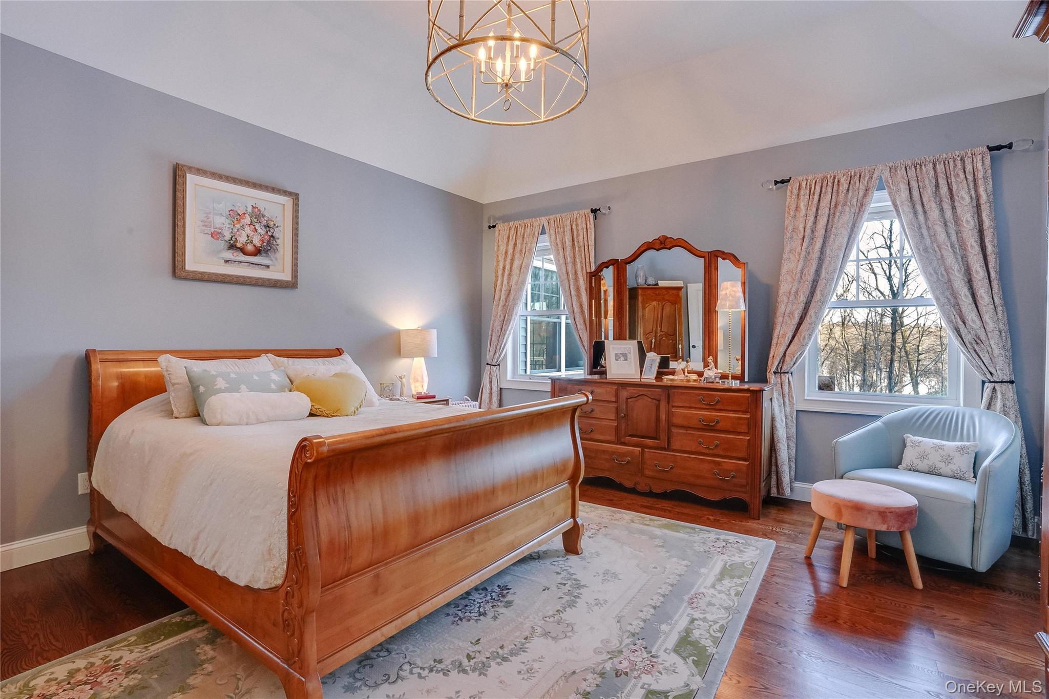 23 Swan Holw Road New Windsor, NY 12553 - Photo 19 of 34 Generously proportioned, this primary bedroom provides plenty of space for relaxation and personal touches, while the thoughtful architectural details add timeless elegance and warmth while looking out on the reservoir.