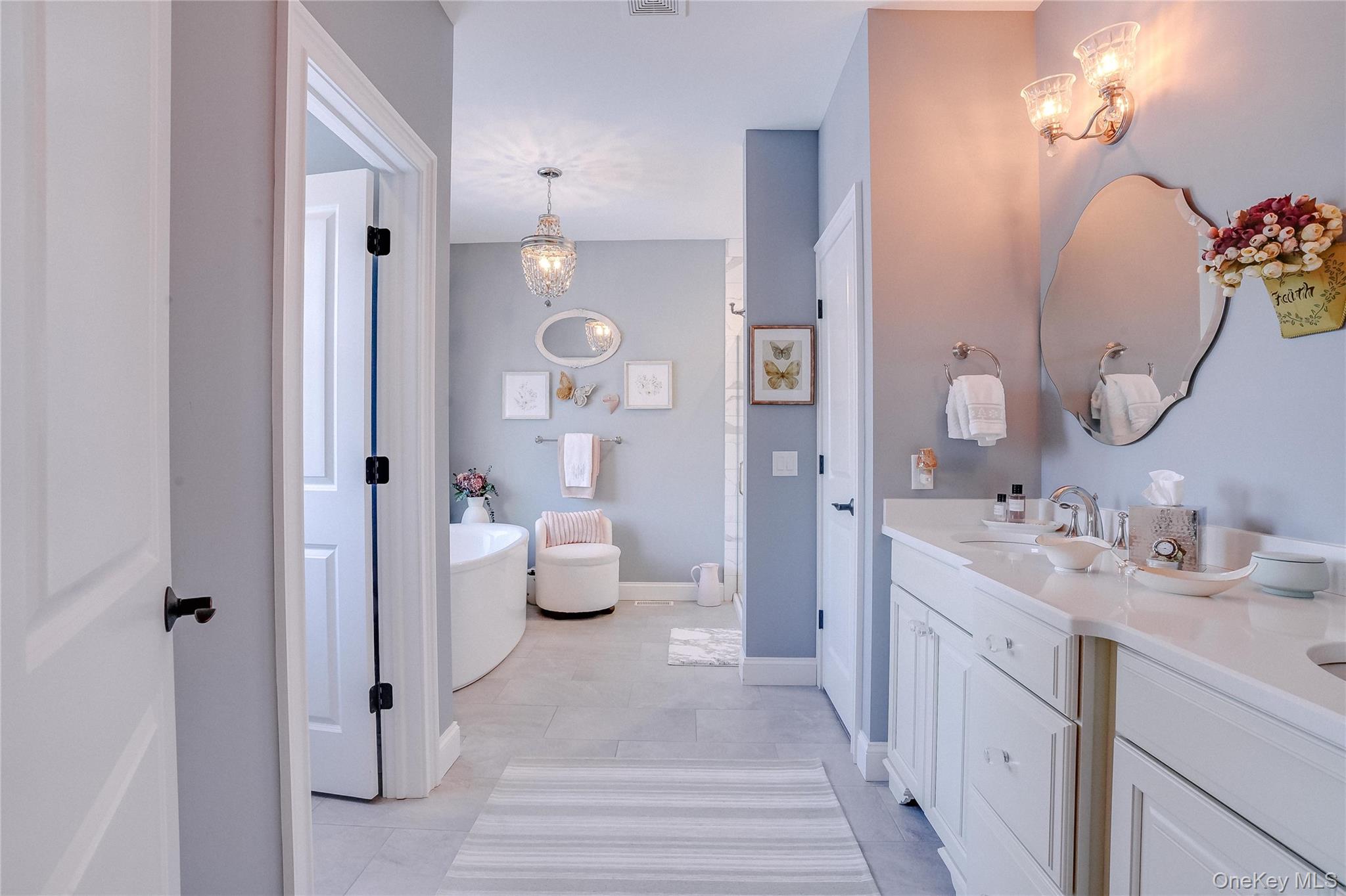 23 Swan Holw Road New Windsor, NY 12553 - Photo 21 of 34 The primary bathroom is a true retreat, featuring a freestanding soaking tub, a spacious walk-in shower, and a double vanity with exquisite detailing.