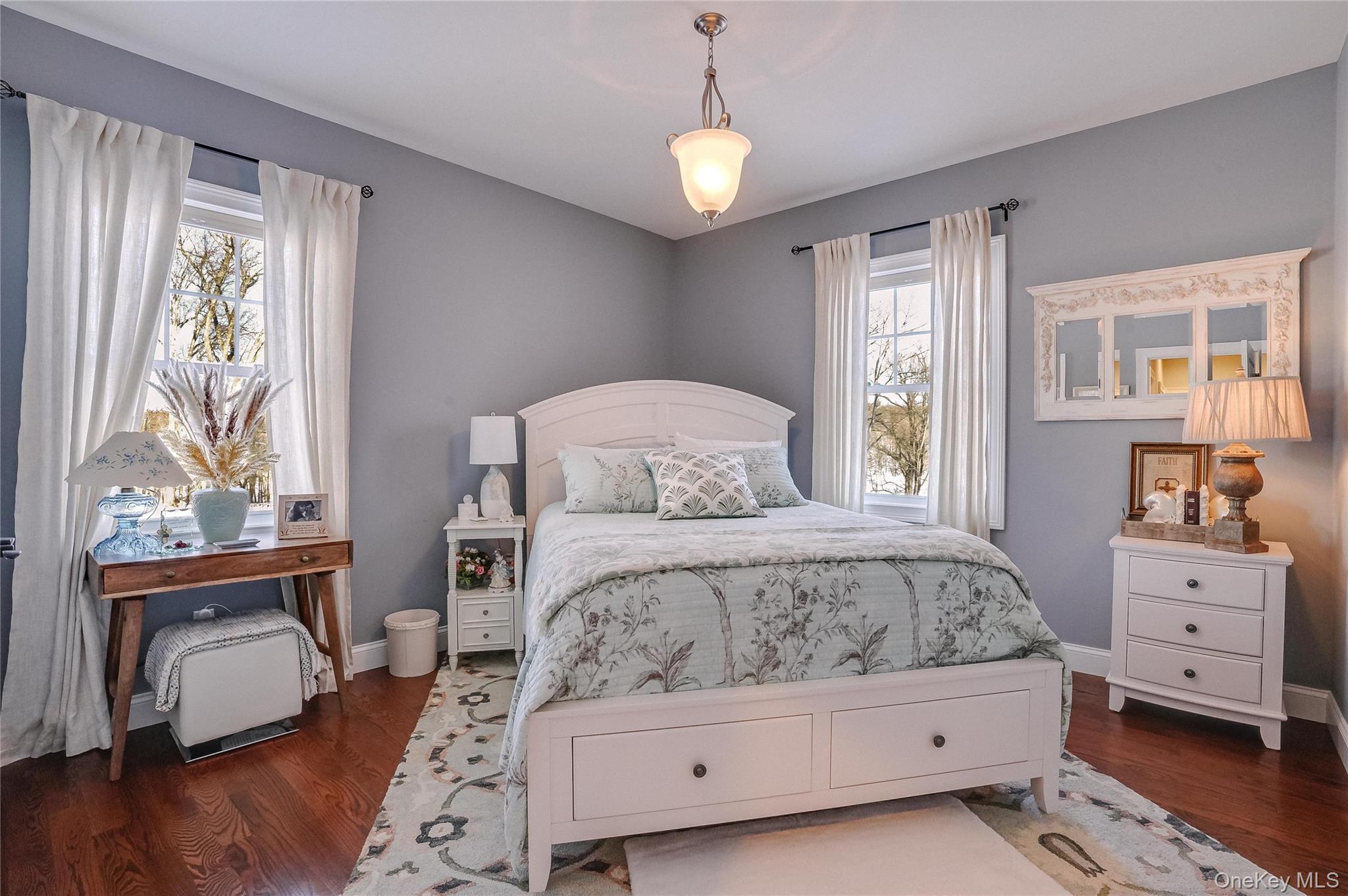 23 Swan Holw Road New Windsor, NY 12553 - Photo 24 of 34 A generous bedroom features hardwood floors, a spacious closet, and serene views of the reservoir, creating a bright and inviting space that combines comfort with a peaceful, scenic backdrop.