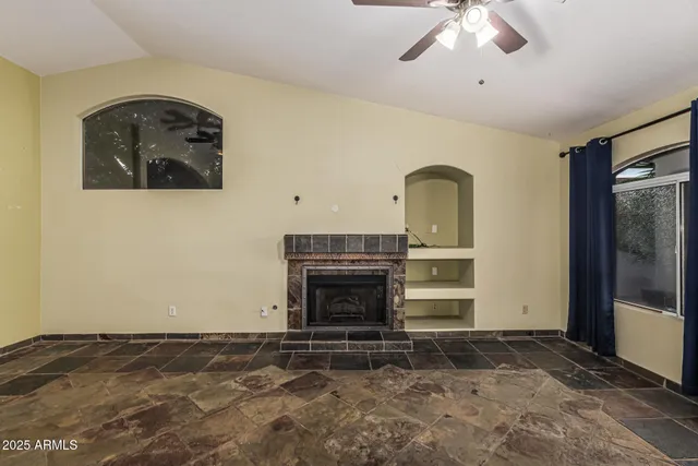 a view of a livingroom with a fireplace a chandelier and closet