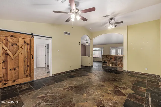 a view of empty room with a fireplace and wooden floor