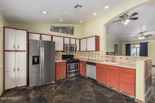 a kitchen with a sink stove and cabinets