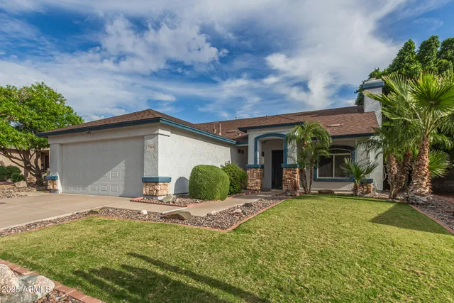 a view of a house with backyard and sitting area