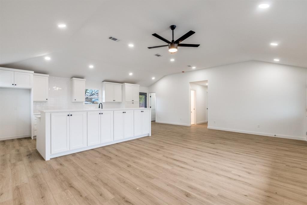 109 East 5th Street Prosper, TX 75078 - Photo 7 of 25 a view of a kitchen with a sink and wooden floor