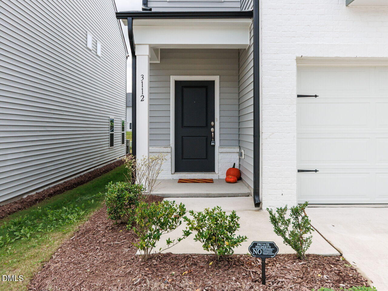 3112 Ranger Drive Durham, NC 27703 - Photo 2 of 35 a front view of a house with lots of flowers