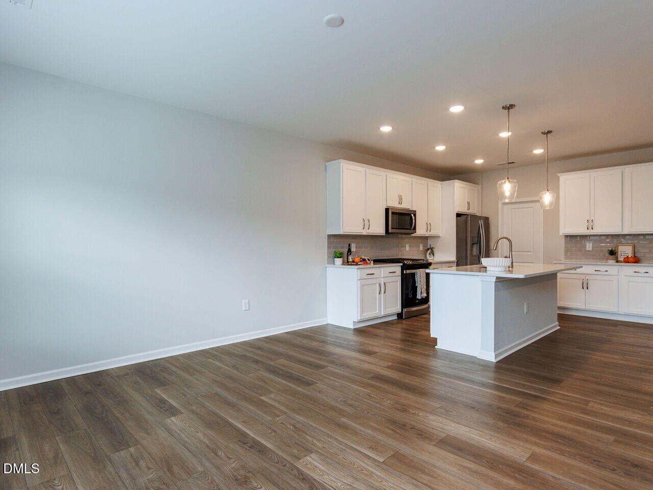 3112 Ranger Drive Durham, NC 27703 - Photo 25 of 35 a view of kitchen with kitchen island granite countertop stainless steel appliances refrigerator sink and microwave