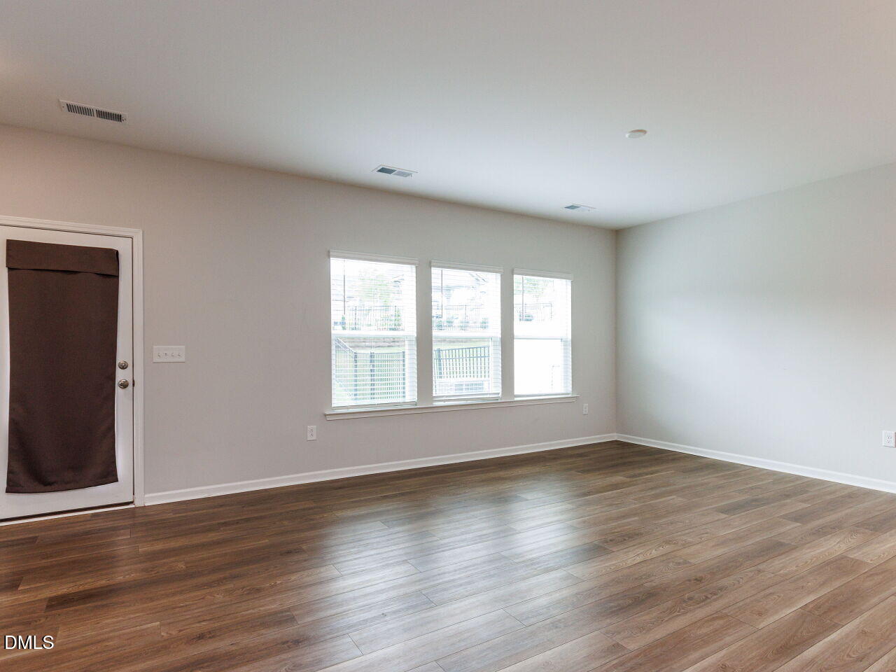 3112 Ranger Drive Durham, NC 27703 - Photo 27 of 35 a view of an empty room with wooden floor and a window