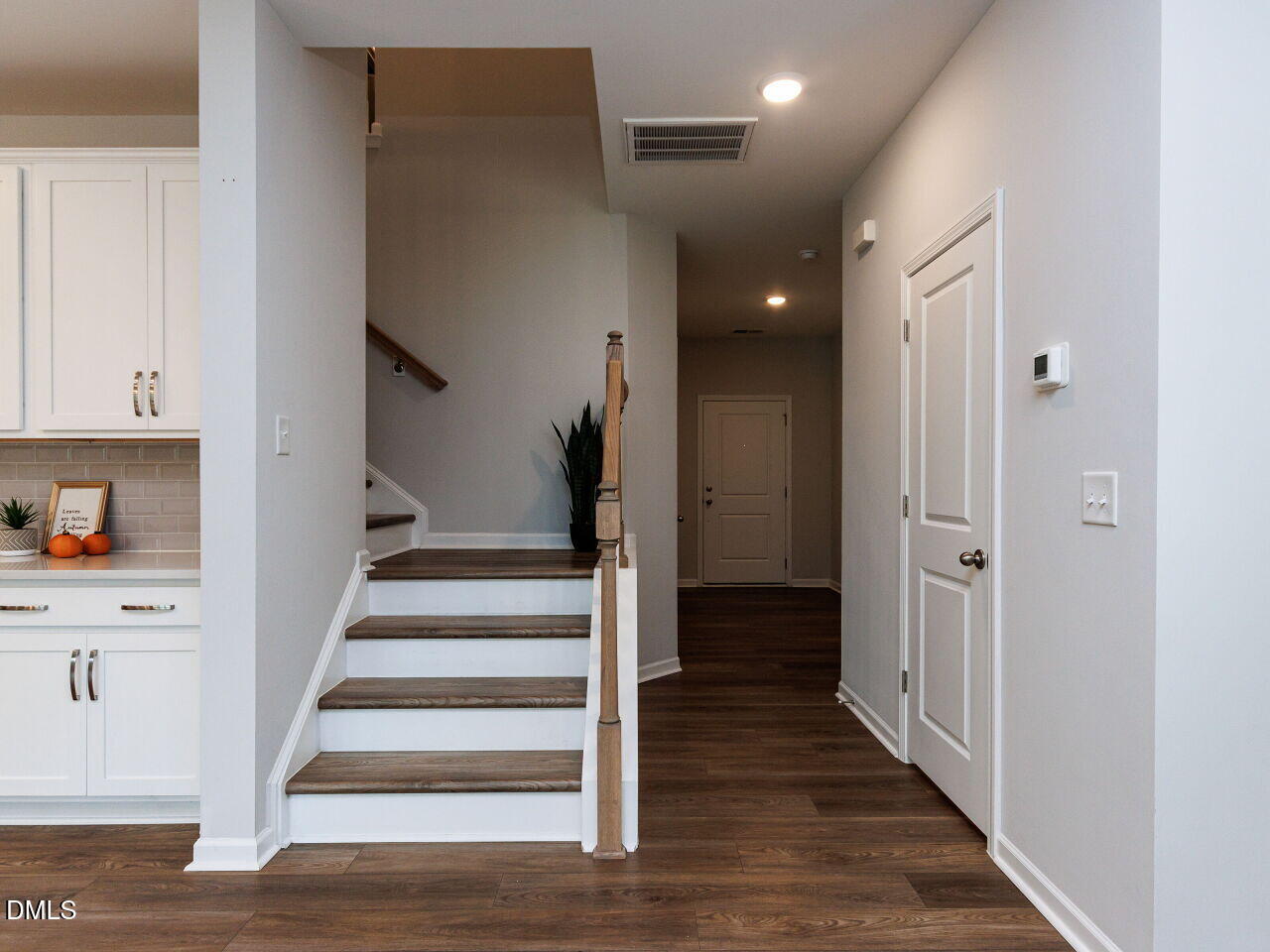 3112 Ranger Drive Durham, NC 27703 - Photo 3 of 35 a view of a hallway with wooden floor and staircase