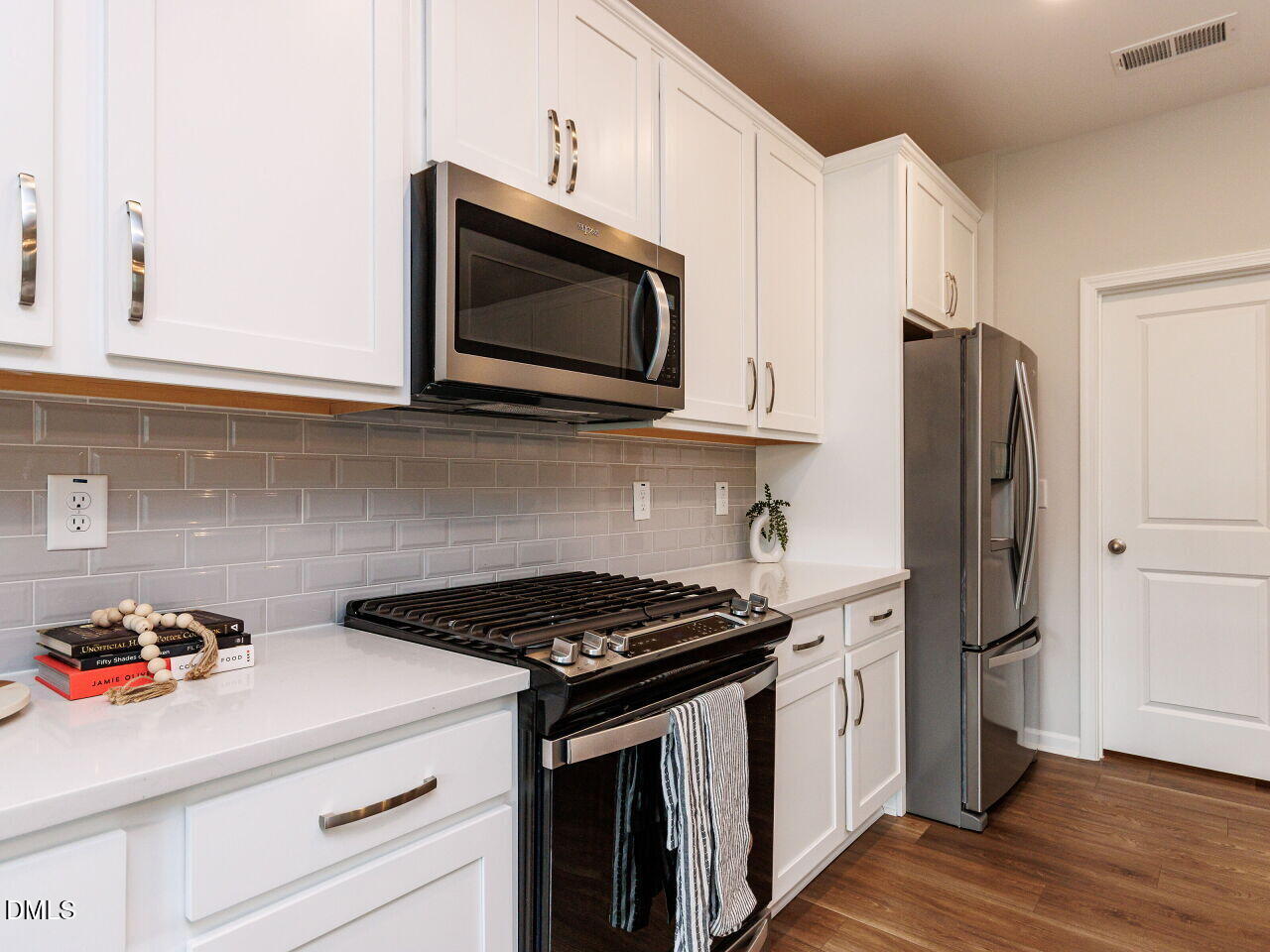 3112 Ranger Drive Durham, NC 27703 - Photo 5 of 35 a kitchen with stainless steel appliances a stove microwave and cabinets