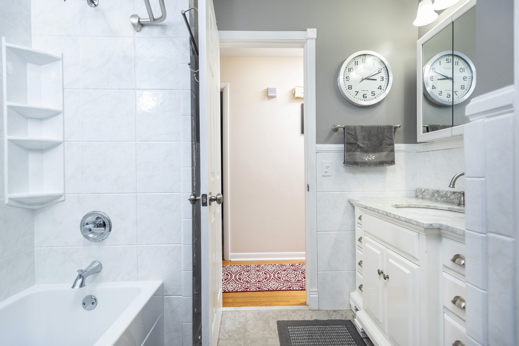8416 Terry Lane Hermitage, TN 37076 - Photo 12 of 24 a bathroom with a bathtub a sink and a large mirror